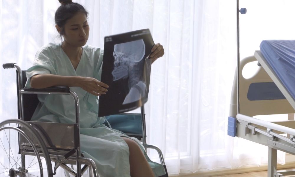 Patient looks at X-ray and ponders a second doctor opinion