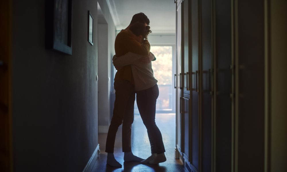 Couple hugging in a hallway