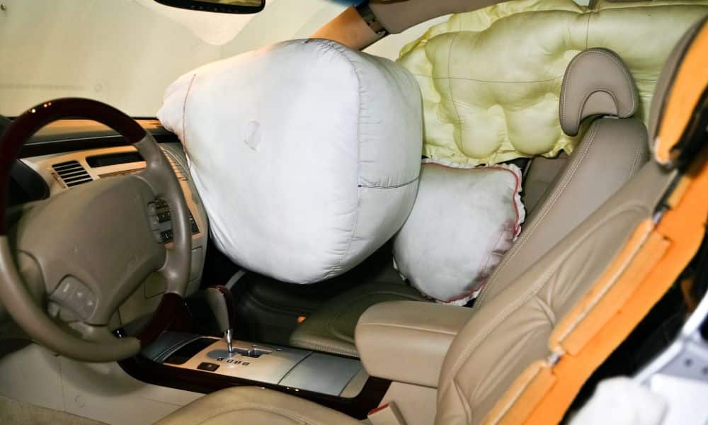 Inside of car with side and driver airbags deployed